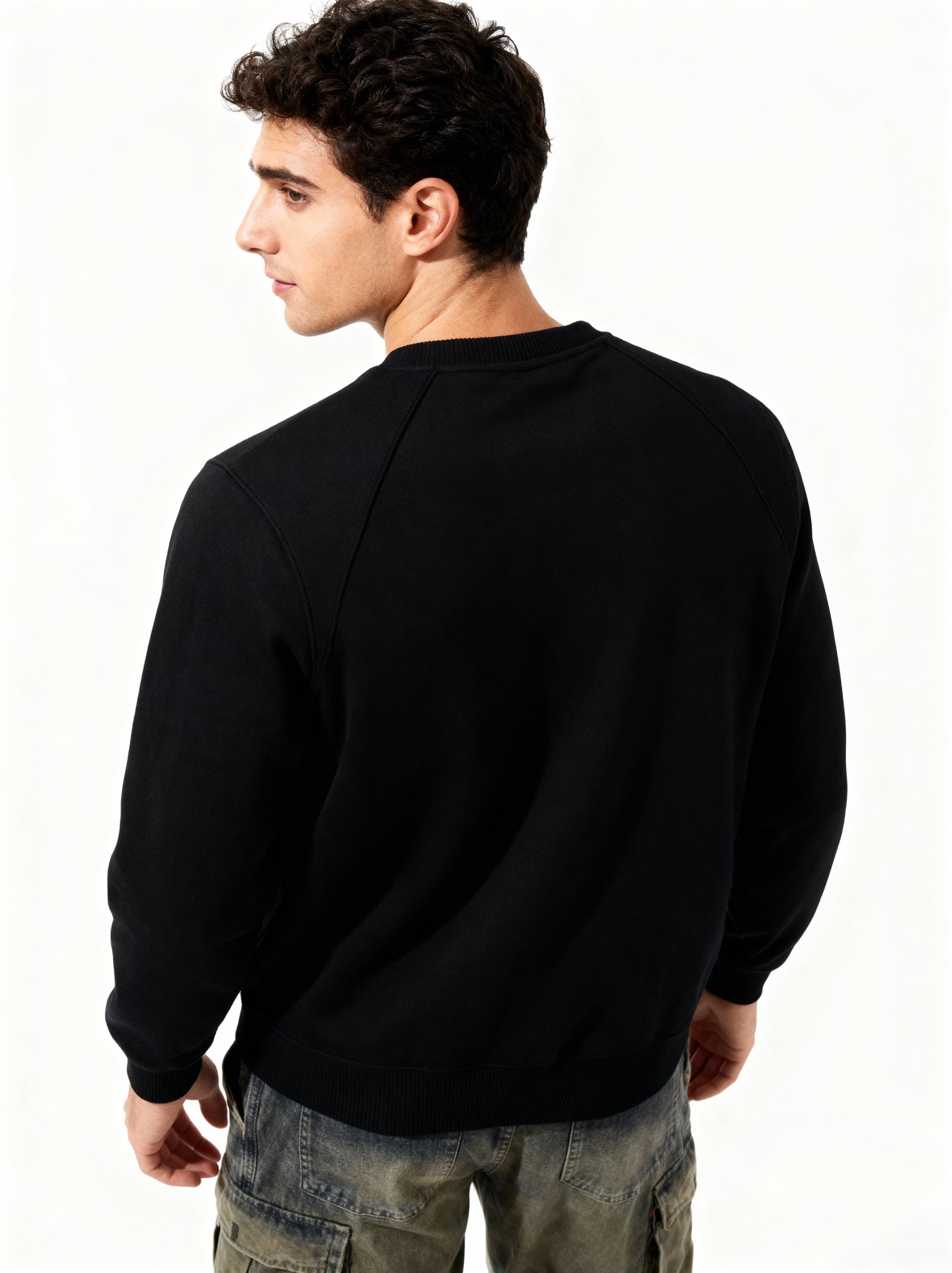 Person wearing a black sweatshirt on a white background