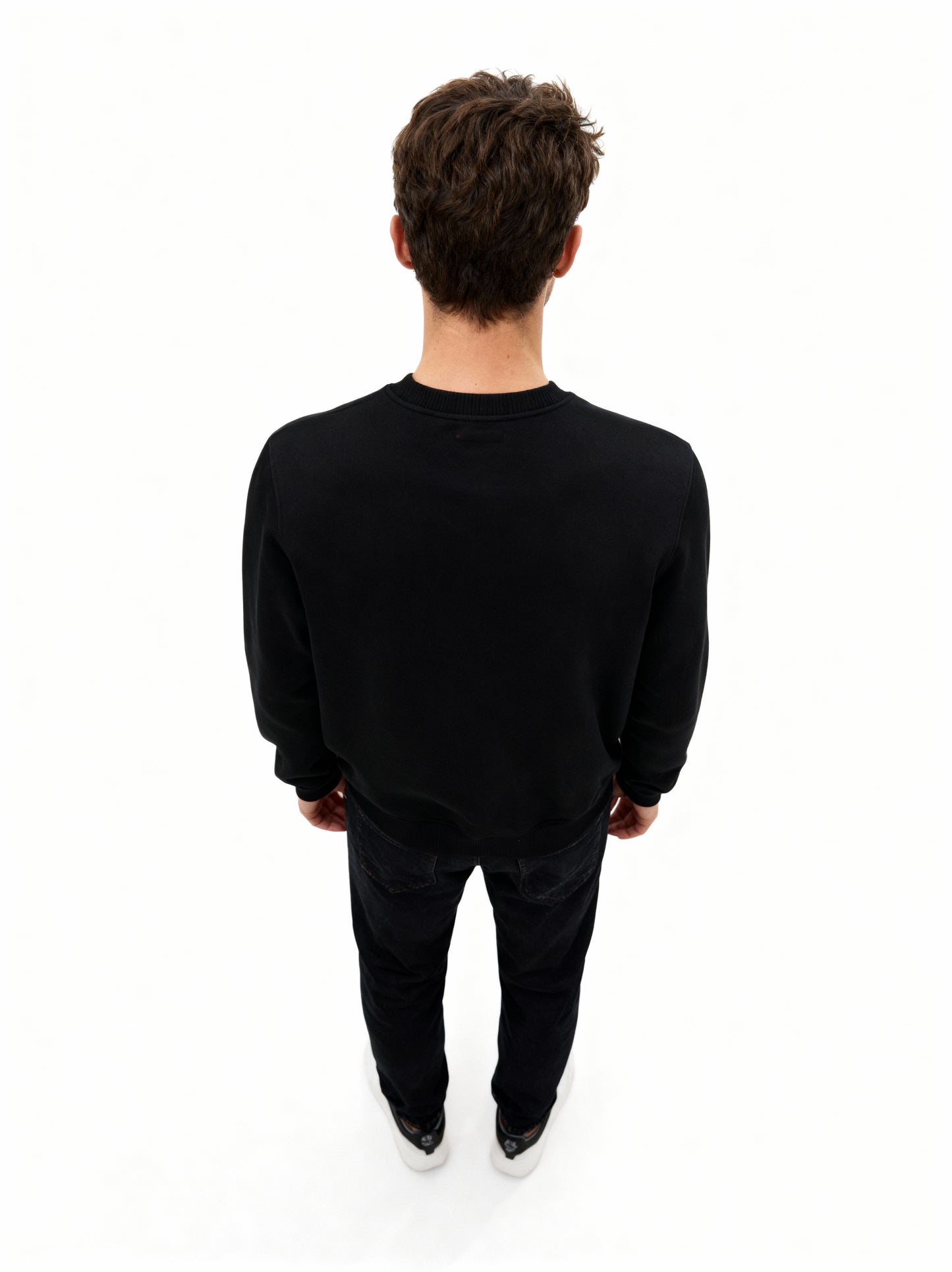 Person wearing a black outfit on a white background