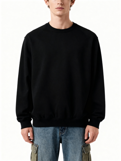 Person wearing a black sweatshirt and blue jeans on a white background