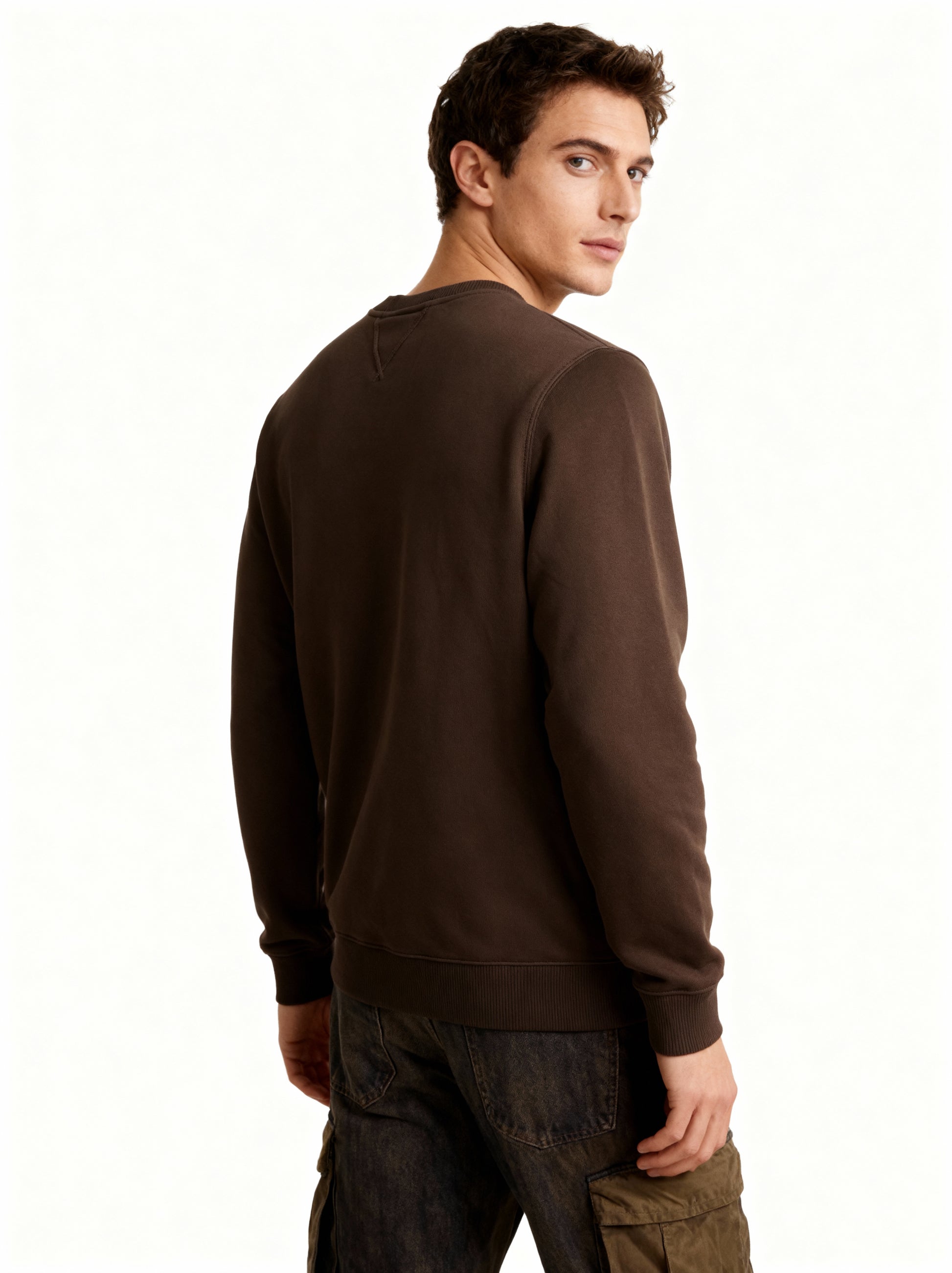 Man wearing a brown sweatshirt on a white background