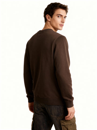Man wearing a brown sweatshirt on a white background