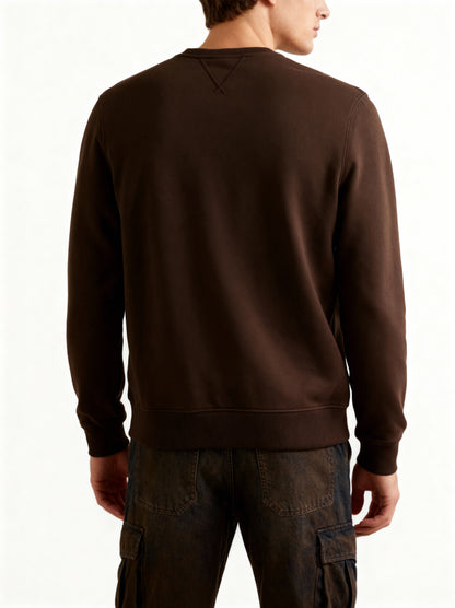 Person wearing a brown sweatshirt on a white background