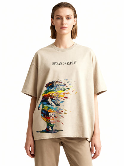 Person wearing a beige t-shirt with a colorful graphic and text 'Evolve or Repeat' on a white background