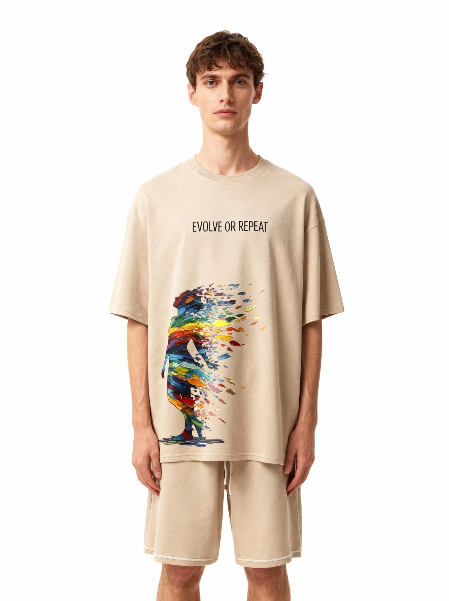 Man wearing a beige t-shirt with 'Evolve or Repeat' text and colorful design on a white background