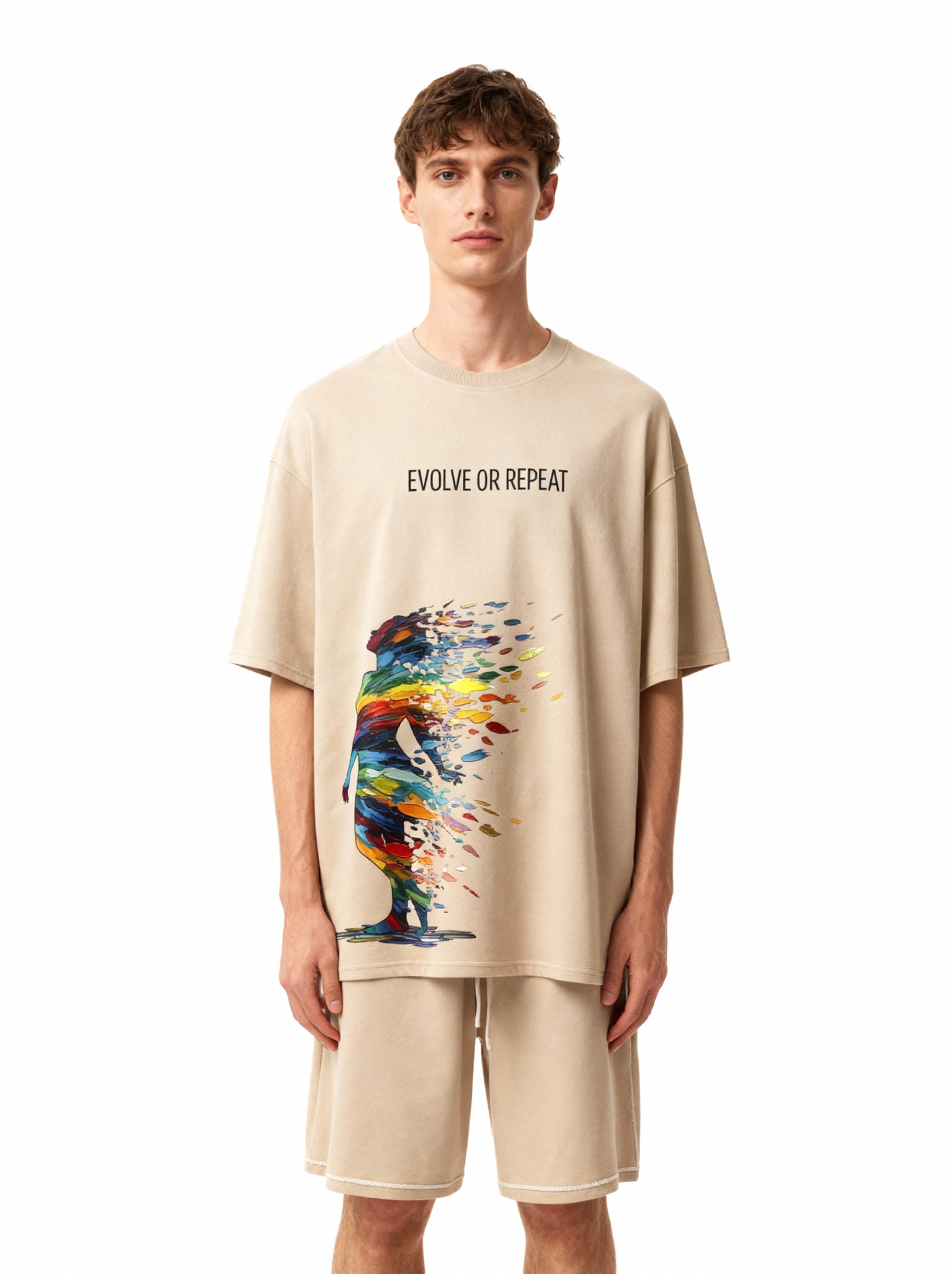 Man wearing a beige t-shirt with 'Evolve or Repeat' text and colorful design on a white background