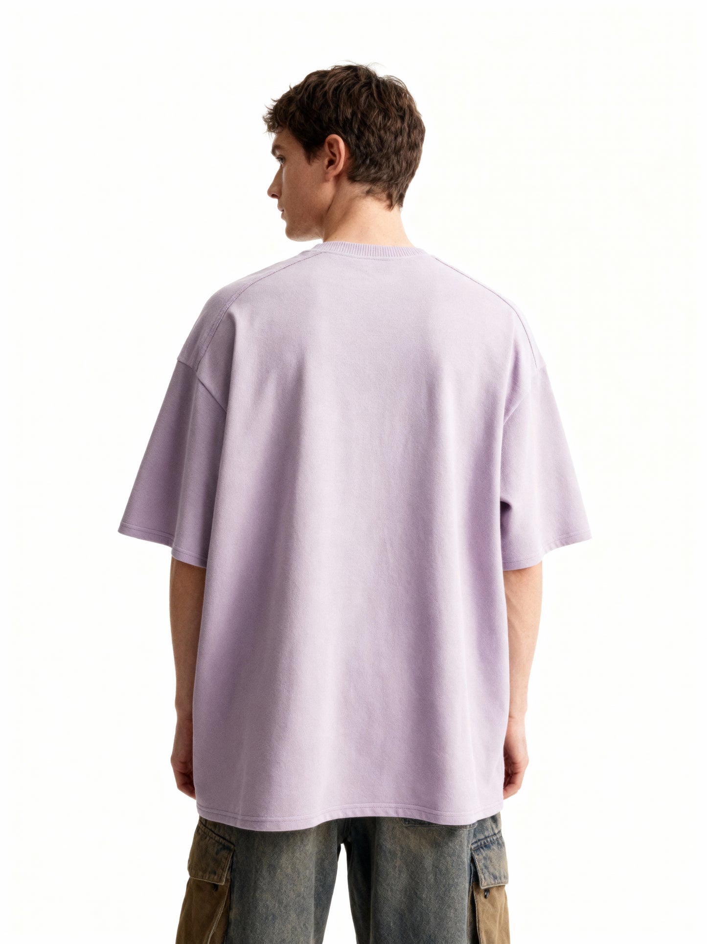 Person wearing a light lavender t-shirt on a white background