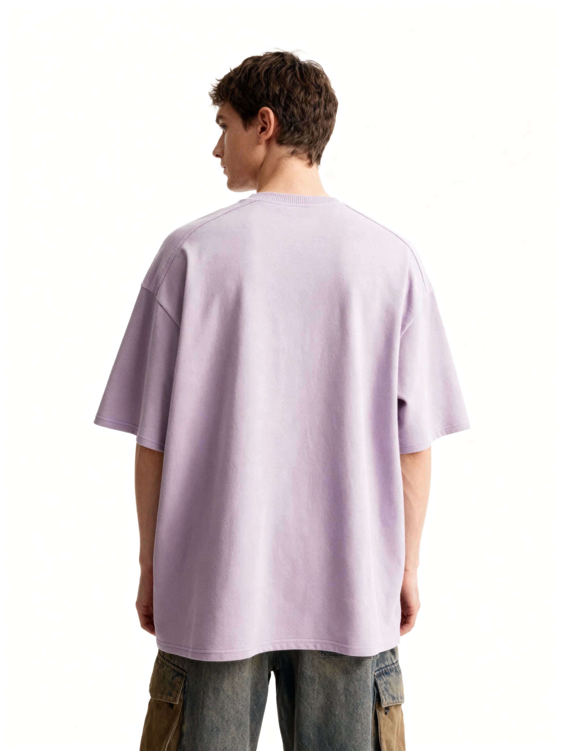 Person wearing a light lavender t-shirt on a white background
