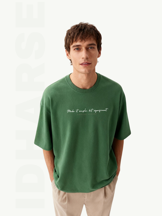 Man wearing a green t-shirt with text on a white background
