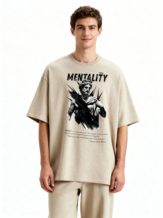 Man wearing a beige t-shirt with graphic design and text on a white background