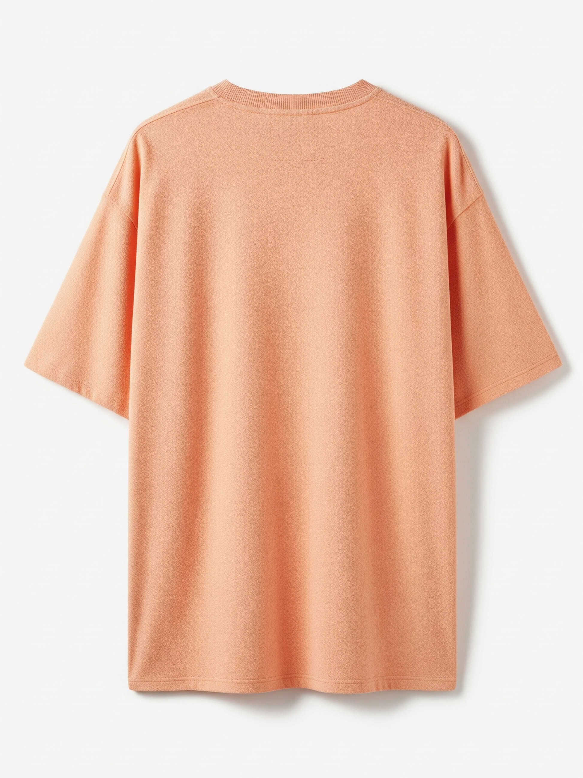 Peach-colored t-shirt on a white background