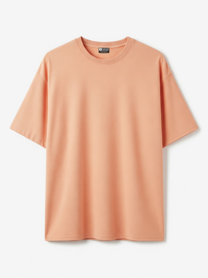 Peach-colored t-shirt on a light gray background