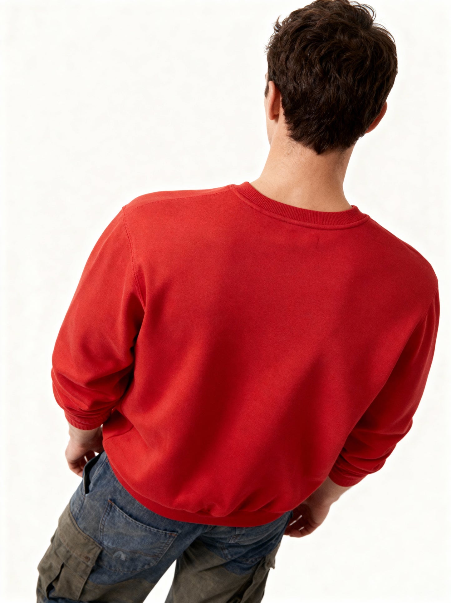 Person wearing a red sweatshirt on a white background