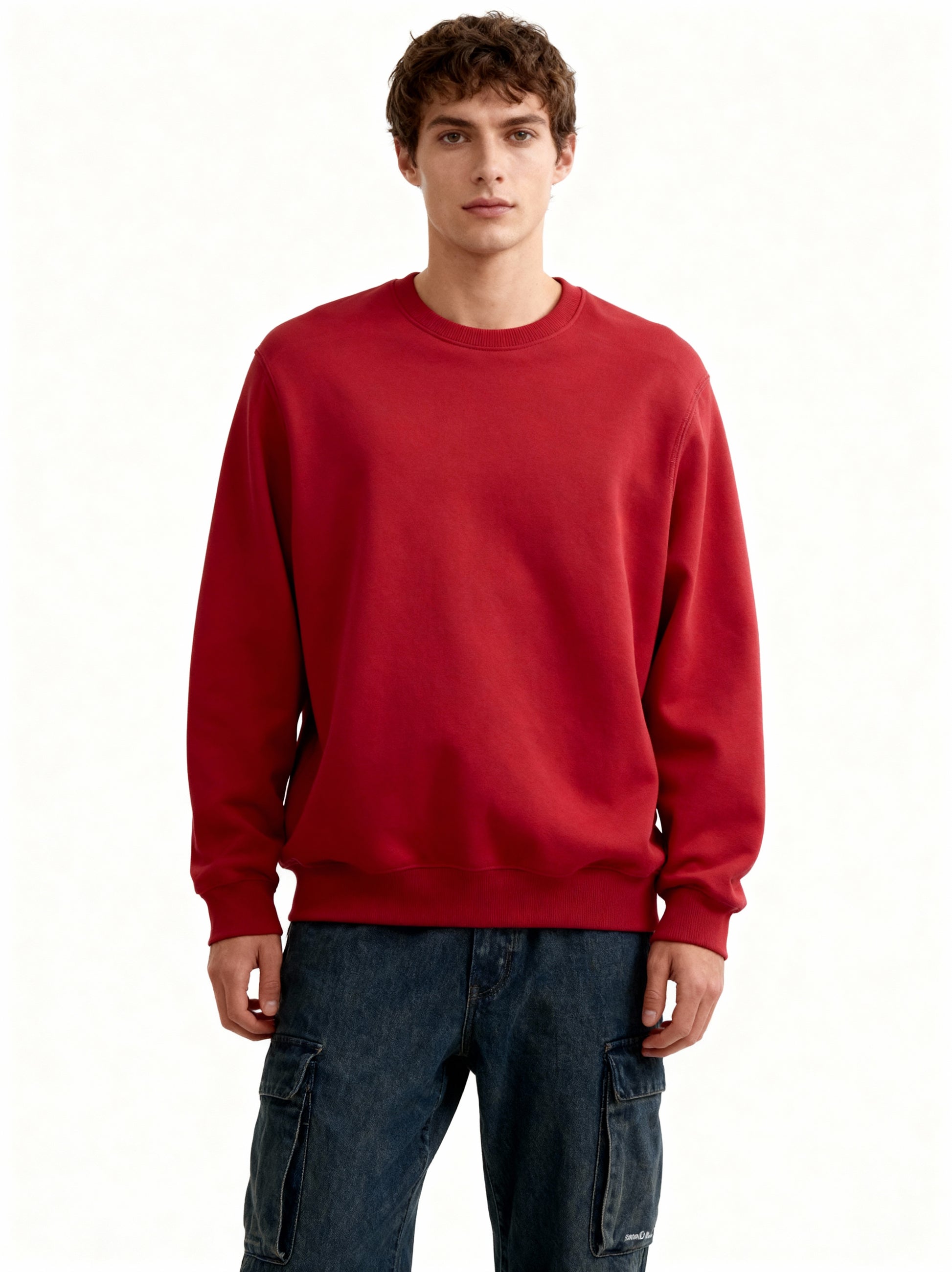 Person wearing a red sweatshirt and blue jeans on a white background