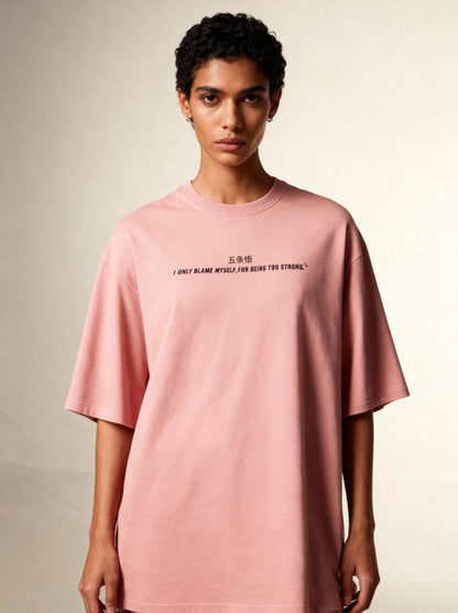 Person wearing a pink t-shirt with text on a plain background