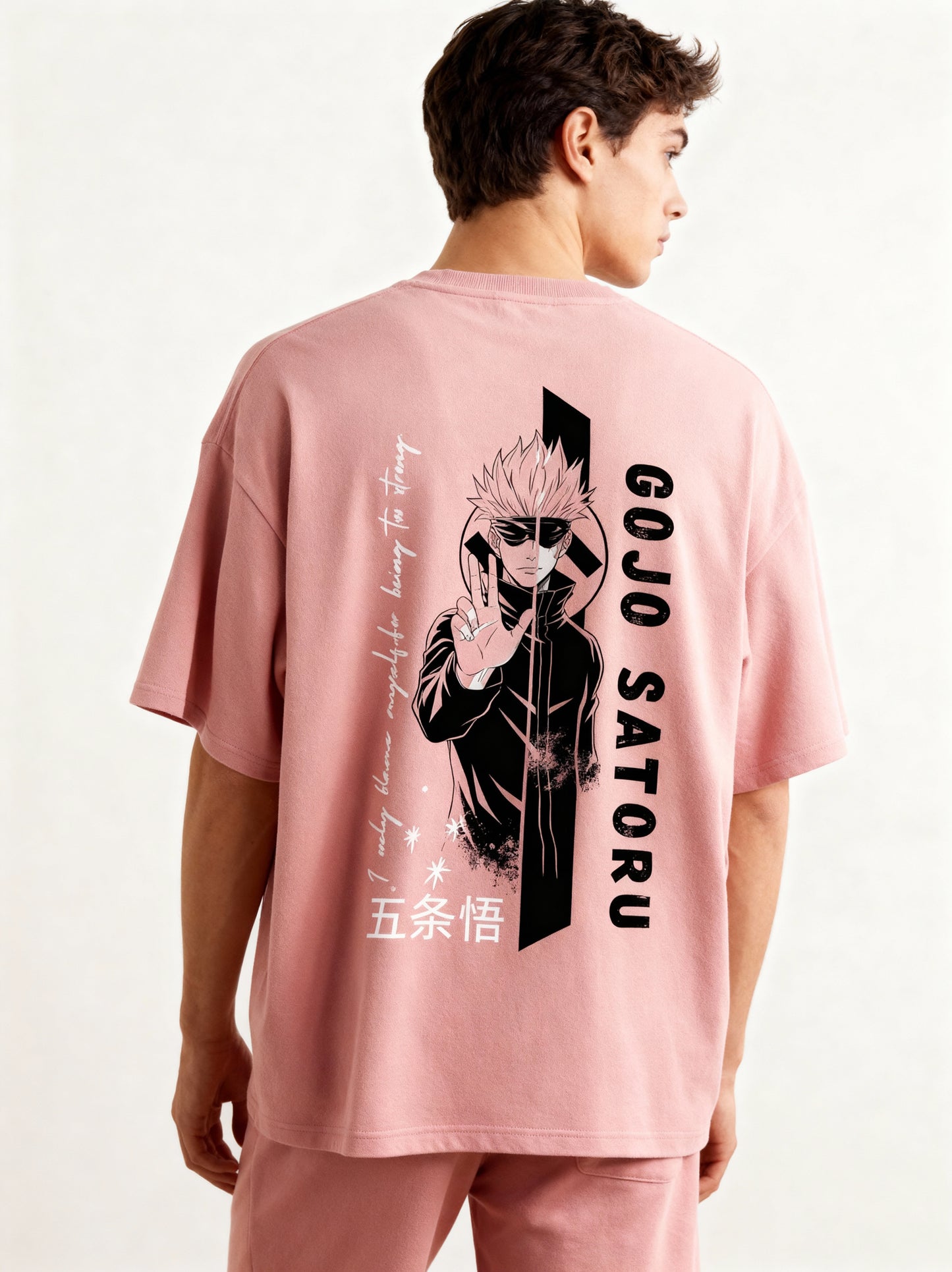 Person wearing a pink t-shirt with 'Gojo Satoru' design on the back