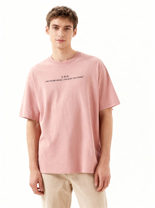 Man wearing a pink t-shirt with text on a white background