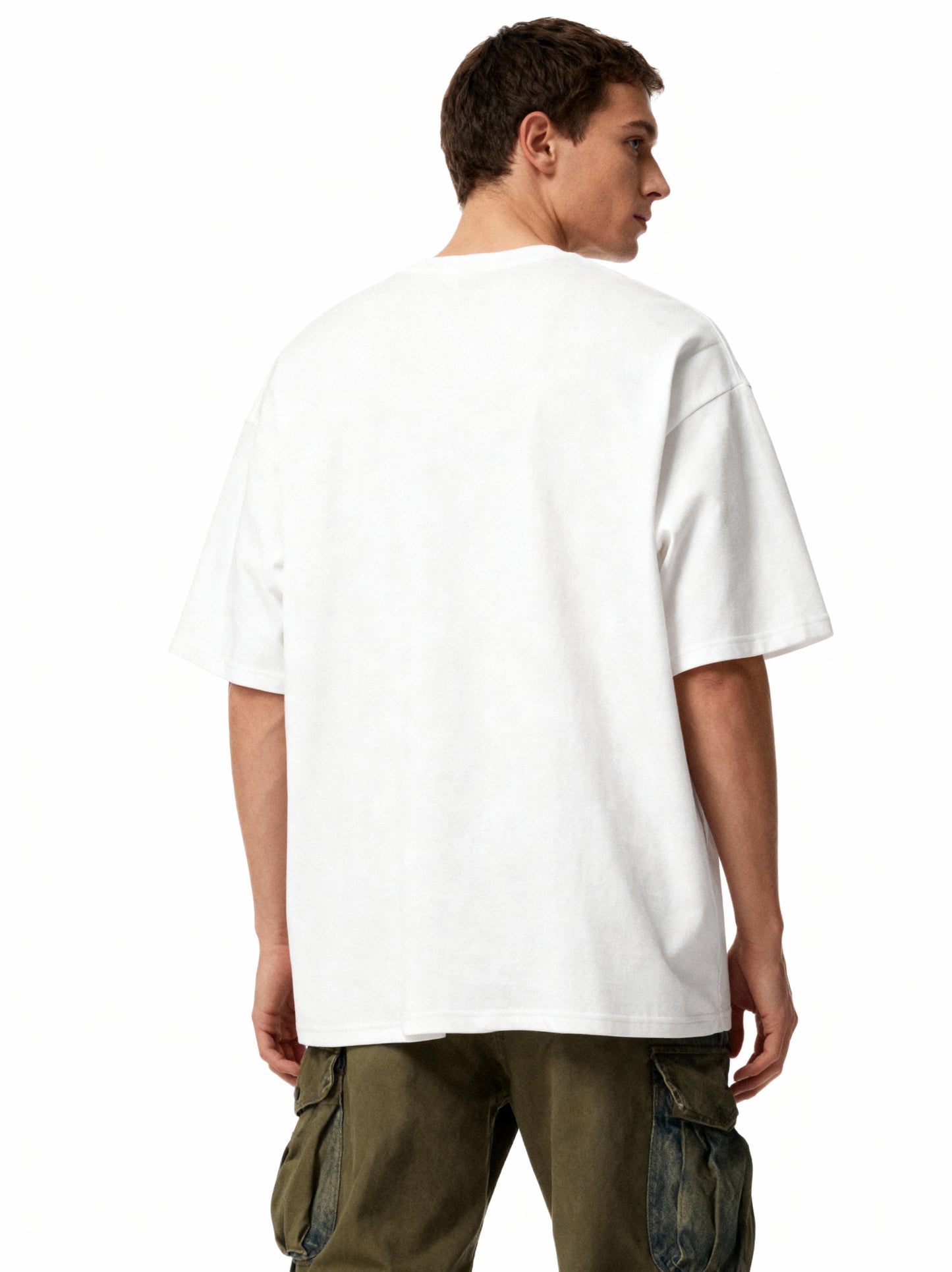 Person wearing a plain white t-shirt and cargo pants on a white background