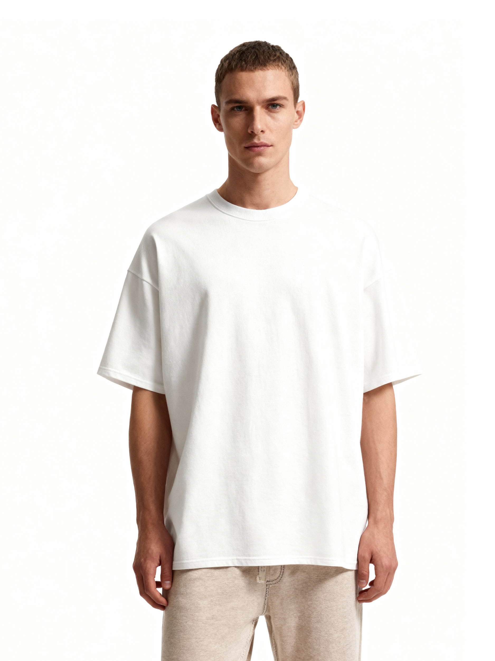 Man wearing a plain white t-shirt on a white background
