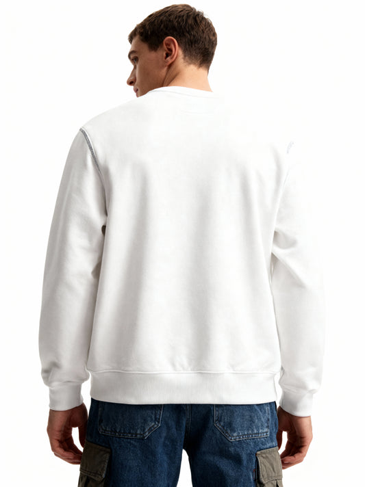 Person wearing a white sweatshirt and blue jeans on a white background