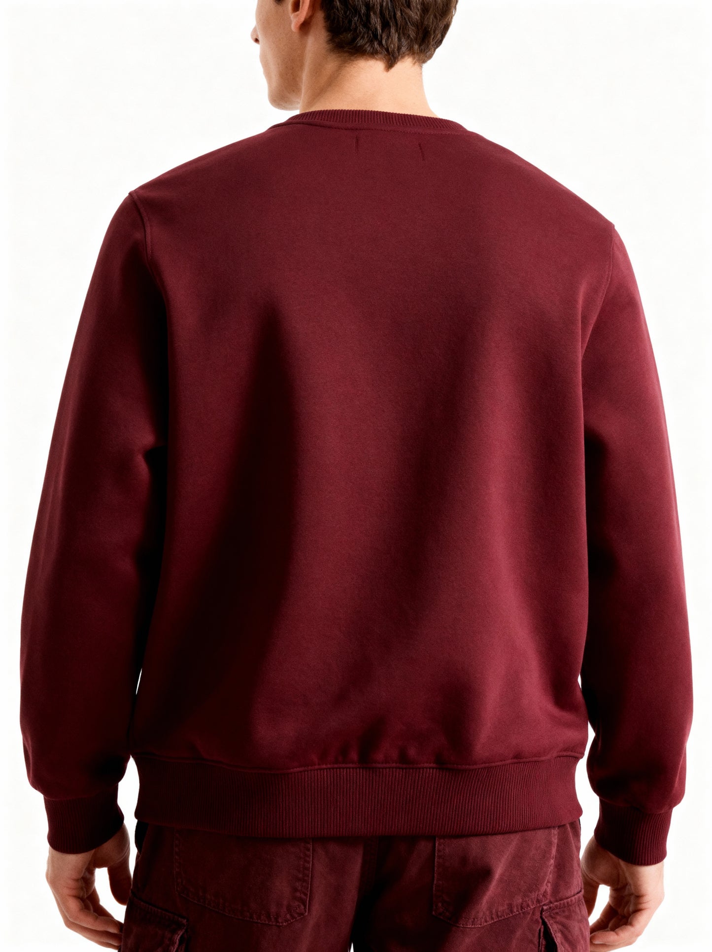 Maroon sweatshirt worn by a person on a white background