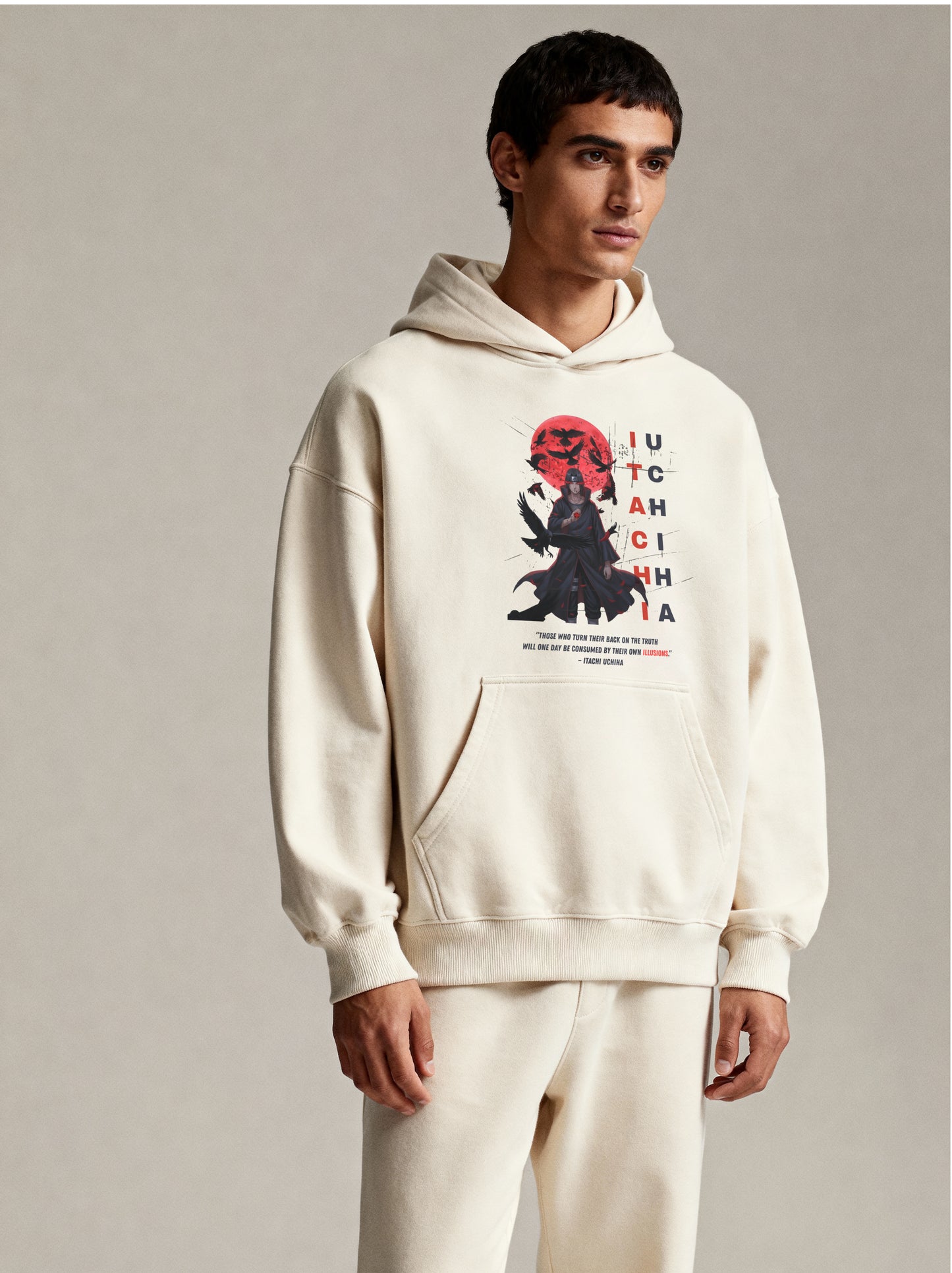 Person wearing a white hoodie with a graphic design on a plain background